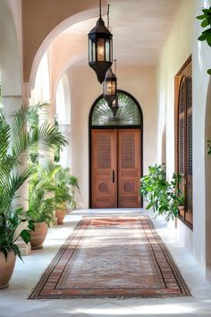 an entrance way with potted plants and hanging lights