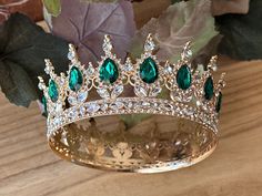 Beautiful, Crown with big Green stones and small Crystal Rhinestone set on Gold Crown. Perfect for Renaissance, Prom, Birthday, Sweet 16, Anniversary, Wedding, or for any other special occasion. Or just to be THE QUEEN. THE COLORS ON THE CROWN: Gold Crown frame, Emerald Green and Crystal Rhinestones. THE SIZE 2.25 inches tall 5 inches diameter GIFT BOX IT'S NOT INCLUDED! This item it will send on STANDARD FIRST CLASS MAIL (2 to 5 business days). in USA If you need sooner, please upgrade the ship Emerald Green Crown, Prom Queen Crown, Crown Frame, Crown Frames, Birthday Crowns, Green Crown, Sweet 16 Themes, Prom Birthday, Crown Gold