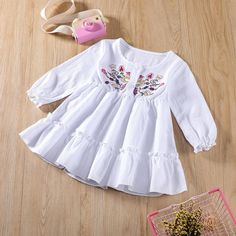 Baby Girls Long Sleeve Embroidered Dress Baby Wholesale Clothing - PrettyKid Long Sleeve Cotton Dress With Floral Applique, Embroidered Cotton Dresses For Baptism, Cotton Embroidered Dress For Baptism, Cotton Dress With Floral Embroidery For Playtime, Sweet Embroidered Cotton Dress, White Long Sleeve Tops For Baptism, Sweet White Dress With Floral Embroidery, Spring Long Sleeve Tops For Baptism, Embroidered Long Sleeve Baptism Dress