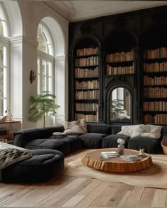 a living room filled with lots of furniture and bookshelves