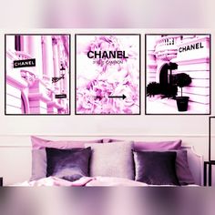 three chanel posters hanging on the wall above a bed