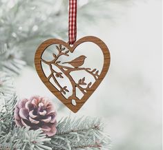 a wooden heart ornament hanging from a christmas tree