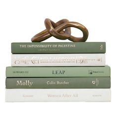 a stack of books sitting on top of each other with an intertwined knot in the middle