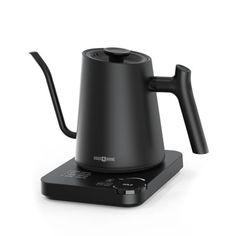 an electric tea kettle sitting on top of a black base with a handle attached to it