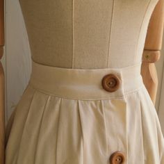 "This item is handmade in pure cotton fabric. Wonderful Italian fabric. Soft but firm hand. The skirt is made with small lateral folds both front and back. It has a short placket on the front, with a metal ciappa. Equipped with a 4 cm high corset, calculated for natural life. The placket with wooden buttons is fake. Finished internally, without lining. It is an elegant garment suitable for special occasions but also casual for use with flat shoes on a daily basis. Made of pure cotton fabric. Des Cotton A-line Gathered Skirt, Elegant Cotton A-line Pleated Skirt, Cotton A-line Pleated Lined Skirt, Classic Cotton Pleated Skirt With Accordion Pleats, Classic Cotton Pleated Waist Skirt, Cotton Tiered Skirt With Pleated Waist, Cotton A-line Pleated Skirt, Pleated Cotton Midi Skirt, Spring Pleated Cotton Maxi Skirt