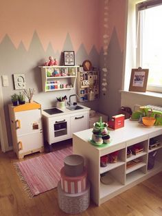 a child's playroom with toys and decor