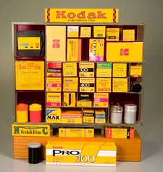 an assortment of products displayed on display in front of a gray background with the words kodak above it