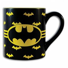 a black and yellow batman mug with bats on it