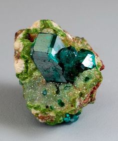 a green and white rock sitting on top of a table