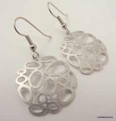 These silver bubble earrings are so fun and unique. They dress up any ensemble in no time. The would even be amazing for the bride who likes to break from the traditional, who likes something a little different - for herself and her bridesmaids! These earrings are lightweight and feature a multiple matte silver plated circular design that is finished off with stainless steel ear wires, for those with sensitive ears. The ear wires can be switched out to silver plated clip-ons, for those with non- Wedding Circle Earrings In Metal, Silver Circle Earrings For Wedding, Modern Nickel-free Wedding Earrings, Medallion Earrings, Bubble Earrings, Circular Design, Chandelier Earrings, Ear Wires, Washington Dc