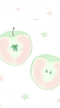 two green apples with pink and white designs on them