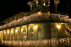 a building with christmas lights on the balconies