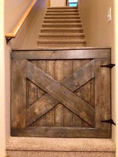 an open wooden door in the corner of a room with stairs and carpet on the floor