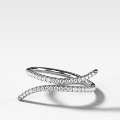 This negative space ring elegantly embraces the finger that wears it with full cut round diamonds in a traditional pave setting. 1.8 mm band 0.15 carats total Stackable Diamond Rings With Pave Setting, Modern Twist Rings With Single Cut Diamonds, Modern Twist White Gold Rings With Diamond Accents, Modern Twist Diamond Ring For Formal Occasions, Modern Twist Brilliant Cut Diamond Ring, Modern Twist Diamond Ring With Round Cut, Diamond White Stackable Rings With Pave Setting, Modern Twist Ring With Diamond Accents, Luxury Diamond White Stackable Rings With Pave Setting