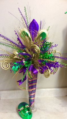 a vase filled with lots of purple and green decorations