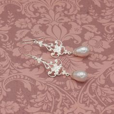 Delightfully elegant and with a Bohemian flair, these earrings are delicate silver floral filigree embellished with pear shaped white crystal pearl dangles. They are the perfect for any occasion. With their timeless design, these earrings make for fabulous gifts for your BFF, Girlfriend, Daughter, Wife, Mother, or Girlfriend. Finished with Sterling Silver ear wires, these are the perfect earring for sensitive ears, and for wowing the eyes. *Handcrafted by Dania De Bortoli *Delicate silver finish over filigree *Pretty leaf shape *Lightweight *Sterling Silver ear wires *Measures  2 1/4 inches (5.5 cm) long and 5/8 inches (1.6 cm) wide. *Variations of design available upon request *See image chart for available finishes  SHIPPING Ships free in the U.S. via U.S.P.S. COMPLIMENTARY GIFT BOX Arri Silver Earrings Wedding, Floral Filigree, Pretty Leaf, Wedding 2024, Wedding Jewelry Earrings, Pearl Earrings Dangle, White Crystal, Etsy Earrings Dangle, Stylish Gifts