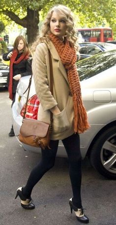 a woman walking down the street carrying a purse