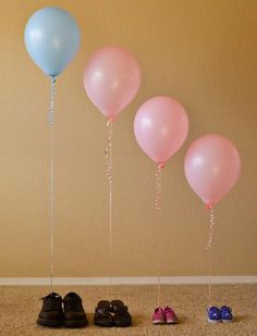 four pairs of shoes are lined up with balloons