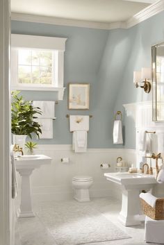 a bathroom with blue walls and white fixtures