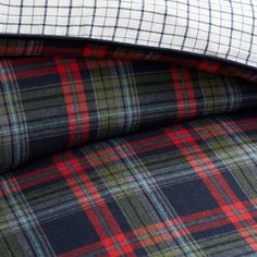 two plaid sheets folded on top of each other, one in blue and the other in red