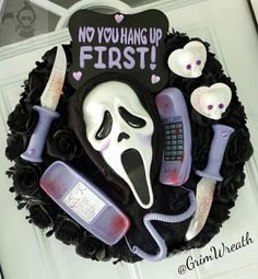 a cake decorated to look like a ghost with makeup and other items around it that say no you hang up first