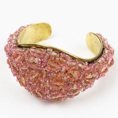 This is part of Chairish’s Costume Jewelry assortment.  Coppola and Toppo designed this fabulous rare cuff bracelet in the 1950s. The bracelet boasts a brass framing and is ornate with multi-strands of beads brought together to form a striking intricate design.  As with all of their necklaces and bracelets, the row of beads appears to have been made from a single, taut thread. This construction creates a subtle and elegant twist belying its true complexity and creating this unusual, flowing desi Vintage Beaded Bracelets For Formal Occasions, Vintage Beaded Bangle Bracelets For Party, Unique Brass Bracelets For Party, Vintage Beaded Bangle Bracelets, Vintage Gold Bracelets With Faceted Beads, Beaded Cuff Jewelry For Party, Vintage Beaded Bangle Bracelet, Vintage Gold Beaded Bracelets With Faceted Beads, Bohemian Beaded Bracelets For Formal Occasions