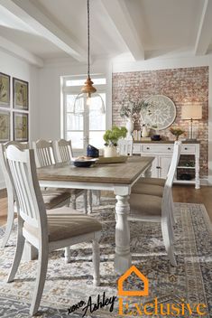 a dining room table with chairs and a rug on the floor in front of it