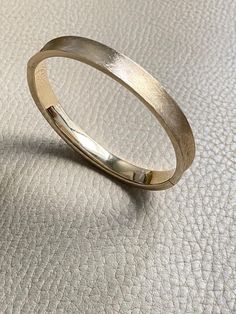 A beauty! 14k gold textured hinged bangle bracelet - 6.9 inch interior A beautiful vintage hollow-form bangle bracelet in 14k gold. She has a concave exterior that has been hand finished with a sublime cross-hatch texture. Bangle interior has a high polish for comfort and visual contrast.    Details  * 12.1g  * 14k gold (not fill or plated)  * Interior oval measures 2 inches (52mm) x 2.4 inches (60mm)  * 6.9 inch interior size approximate  * Hallmark with 14k inside heart outline   * 8mm wide  * Well working clasp with secure safety  * Very good condition with normal age related wear This listing is for 14k textured bangle only. Other bracelets are for inspiration and are sold separately [in my shop here](https://www.scabbyrobot.com/collections/jewelry-box "My jewelry box")   Not sure it w Hollow Form, Heart Outline, Hinged Bangle, Gold Texture, Bracelet Sizes, Bangle Bracelet, My Jewellery, Bangle Bracelets, Jewelry Box