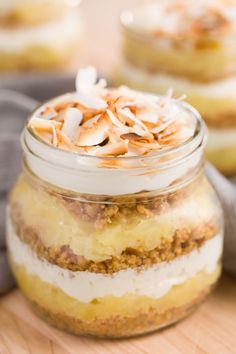 a jar filled with dessert sitting on top of a wooden table