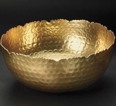 a gold bowl sitting on top of a table