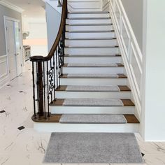 a staircase with carpeted steps leading up to the second floor