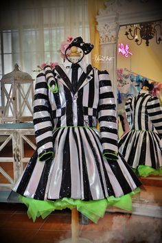 two mannequins dressed in black and white striped clothing