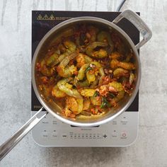 a pan filled with food sitting on top of a stove