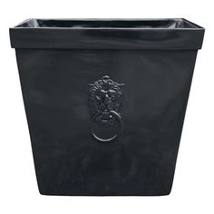 a large black planter with a lion head on the front and bottom part of it