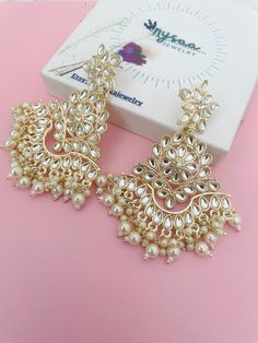 Defined by a gold-tone finish, these sophisticated Kundan earrings embody the elegance of any festive/party look. Very lightweight earrings and pasa. Length: , 3.5 inches  Jewelry care: Avoid Contact With Perfumes, Sprays, Chemicals and Water. Keep your Jewelry in a Clean, Dry and Airtight Box.  Wipe it using a Soft Cloth Regularly Luxury Kundan Danglers For Party, Luxury Traditional Bridal Earrings For Diwali, Cheap Chandbali Chandelier Earrings For Festivals, Luxury White Chandbalis For Festive Occasions, Cheap Gold Chandbali Jewelry, Luxury Formal Chandbalis For Festive Occasions, Bollywood Style Pearl Bridal Earrings For Festive Occasions, White Gold Plated Pearl Earrings For Party, Gold Chandbali Pearl Earrings For Party