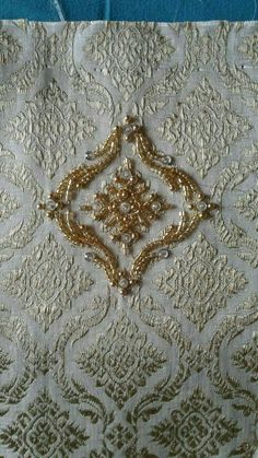 the fabric has been stitched together with gold thread