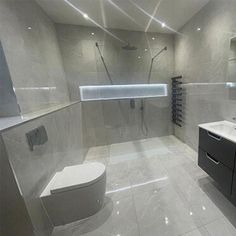 a modern bathroom with two sinks and a toilet