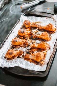 some chicken wings are sitting on a baking sheet and ready to go into the oven