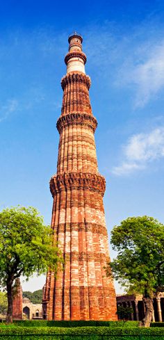 a tall brick tower sitting in the middle of a park