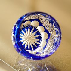 a blue glass bowl sitting on top of a table