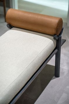 a close up of a chair with a cushion on it's armrests