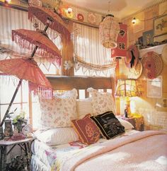 a bed room with a neatly made bed and lots of hanging items on the wall