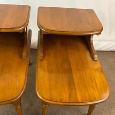 two wooden tables sitting next to each other