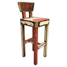 an old wooden chair with writing on the back and seat is red, white, and blue