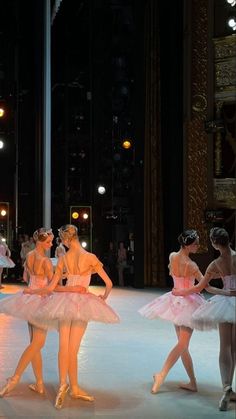 several ballerinas dressed in pink tutus and ballet shoes are on the stage