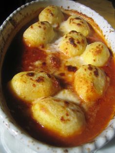 a white bowl filled with food on top of a table