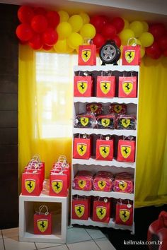 a room filled with lots of red and yellow bags next to a shelf full of balloons