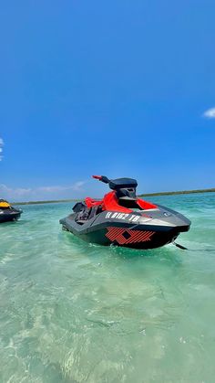 two jet skis are in the clear blue water