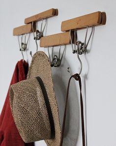 a hat hanging from hooks on a wall