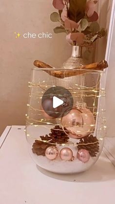 a vase filled with christmas ornaments on top of a table